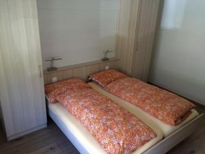 three beds are lined up in a room at Apartment Chalet Sunstar- grosse Wohnung by Interhome in Saas-Fee