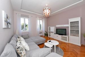a living room with a couch and a tv at Apartman Nikki Kolovare Beach in Zadar +38 photos