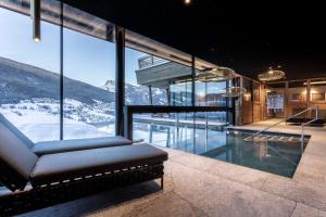 a house with a pool with a mountain view at Hotel Niblea Dolomites in Ortisei
