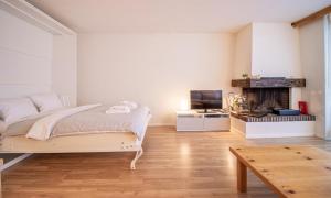 a bedroom with a bed and a fireplace at Rothornblick 57 by Arosa Holiday in Arosa