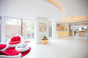 ein Wohnzimmer mit roten Kissen auf einem roten Teppich in der Unterkunft Hotel Krone OHG in Gerlingen