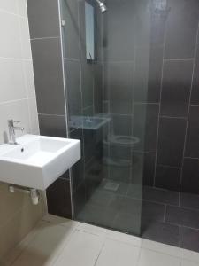 a bathroom with a sink and a shower at FZ Almyra Homestay in Kajang