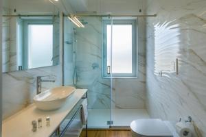 a bathroom with a sink and a shower at Mercury Rooms in Cagliari