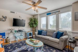 a living room with a couch and a tv at Tybee Escape in Tybee Island