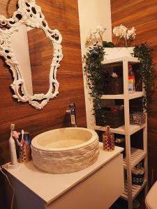 a bathroom with a large sink and a mirror at Mermaid House- pareado boutique - playa a 200m- pases para piscina externa in Chiclana de la Frontera