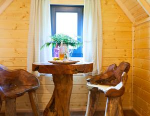 a table in a room with two chairs and a window at Pinewood Park - Tipis, Hot Tubs and Lodges in Scarborough
