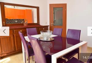 a dining room with a purple table and purple chairs at Villa D in Trogir