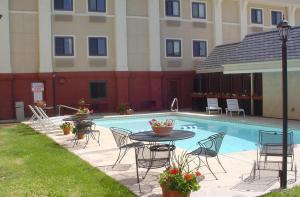 a patio with a table and chairs next to a pool at Quality Inn Grand Junction near University in Grand Junction