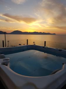 a hot tub with the ocean in the background at Marina Holiday & Spa in Balestrate