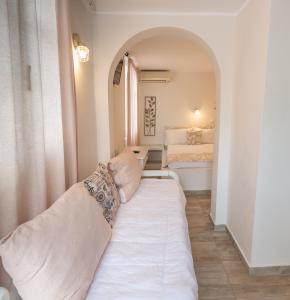 A bed or beds in a room at Naxos Enjoy Apartments