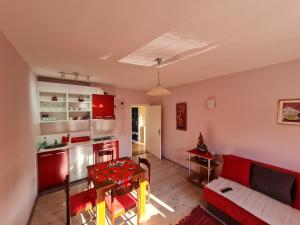 a living room with a red couch and a table at Apartman "Nina" in Soko Banja