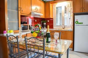 a kitchen with a table with a bottle of wine at Sofi - Stavros Studio in Agalianós