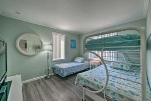 a hospital room with two bunk beds and a mirror at Beach Block Wildwood Condo - Proximity to Dining! in Wildwood