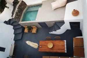 a wall that has a painting of a house at Santorini Folia Cave house, 4 pers, view, jacuzzi in Pirgos