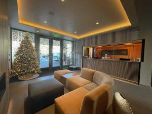a living room with a christmas tree and a couch at Aspen Square Condominium Hotel in Aspen