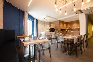 a dining room with wooden tables and chairs at Hotel Garden in Levanto
