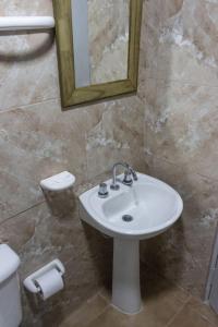 a bathroom with a sink and a mirror and a toilet at Rincón Azul in San Rafael +42 photos