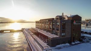 um edifício na neve ao lado de um corpo de água em Pier B Resort em Duluth