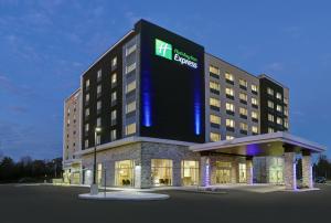 a hotel with a large sign on the front of it at Holiday Inn Express - Kingston West, an IHG Hotel in Kingston