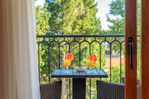 a table with two glasses and a bowl on a balcony at Luxury Apartments Queen in Petrovac na Moru