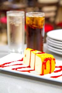 a piece of cake on a plate with sauce at Clarion Inn & Suites Miami International Airport in Miami