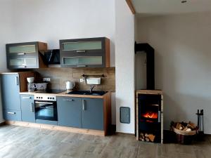 a kitchen with a stove and a fire in it at Ferienhaus Britta Kietzmann in Feldberg