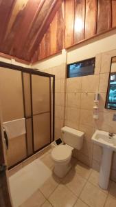 a bathroom with a toilet and a sink at Bella Vista Lodge in Monteverde Costa Rica