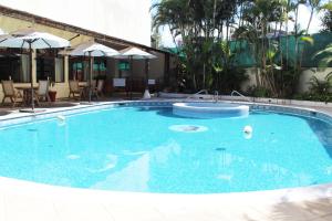 a large pool with blue water in a hotel at Hotel Las Americas in Guatemala