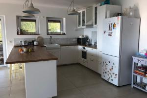 a kitchen with white appliances and a white refrigerator at The Vercors Superb accommodation in the hills #L1 in Seyssinet-Pariset