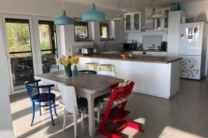 a kitchen with a table and chairs in a kitchen at The Vercors Superb accommodation in the hills #L1 in Seyssinet-Pariset