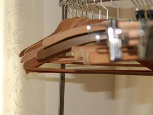a group of wooden hangers in a bathroom at Basel Charme Apartments in Basel