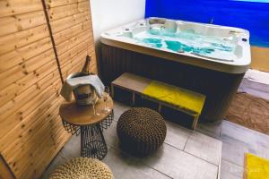 a bathroom with a bath tub and a sink at Élysée Hôtel in Châteauroux