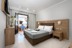 a hotel room with a bed and a television at Corfu SunGate Hotel in Sidari