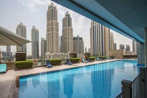 a swimming pool with a view of a city skyline at GuestReady - Downtown Boulevard in Dubai