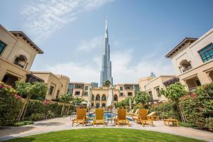 a courtyard with chairs and the burj khalifa in the background at GuestReady - The Middle-Eastern Dream in Dubai