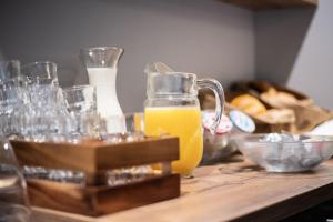 a table with glasses and a jug of orange juice at Hotel Gerig in Wassen
