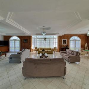 ein großes Wohnzimmer mit Sofas und einem Tisch in der Unterkunft Grand Ville Hotel in São Lourenço