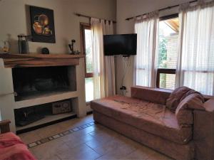 a living room with a couch and a fireplace at Hermosa casa en Potrero de Garay in Potrero de Garay