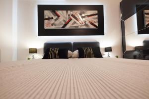 A bed or beds in a room at Apartman Aurelius - private parking