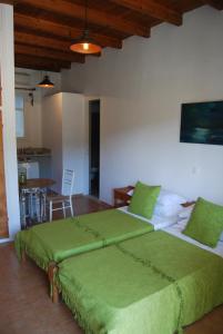 A bed or beds in a room at Pebbles of Kioni