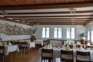 a dining room with white tables and chairs at Gasthaus Krone Lenggenwil in Zuckenriet