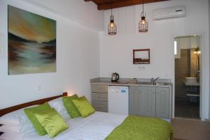 A bed or beds in a room at Pebbles of Kioni
