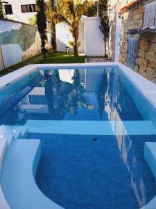 a swimming pool with a blue pool at Hotel Ariana in San Pedro La Laguna
