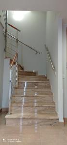 a staircase in a building with wooden floors and rails at Casa Familiar Vacaciones in Sant Carles de la Ràpita