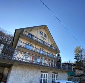 a large building with balconies on the side of it at Lužnjanin restoran i sobe in Jošanička Banja