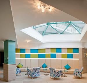 a waiting room with chairs and a skylight at Hotel Boryana in Albena