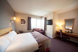a hotel room with a bed and a desk at Leonardo Hotel Derby in Derby +32 photos