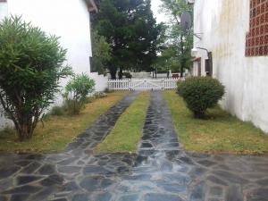 un chemin pavé devant une maison dans l'établissement Duplex cerca del Mar en Las Toninas, à Las Toninas