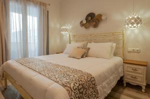 A bed or beds in a room at Naxos Enjoy Apartments