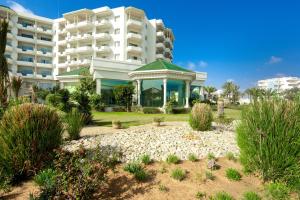 a large building with a garden in front of it at Iberostar Selection Royal El Mansour in Mahdia